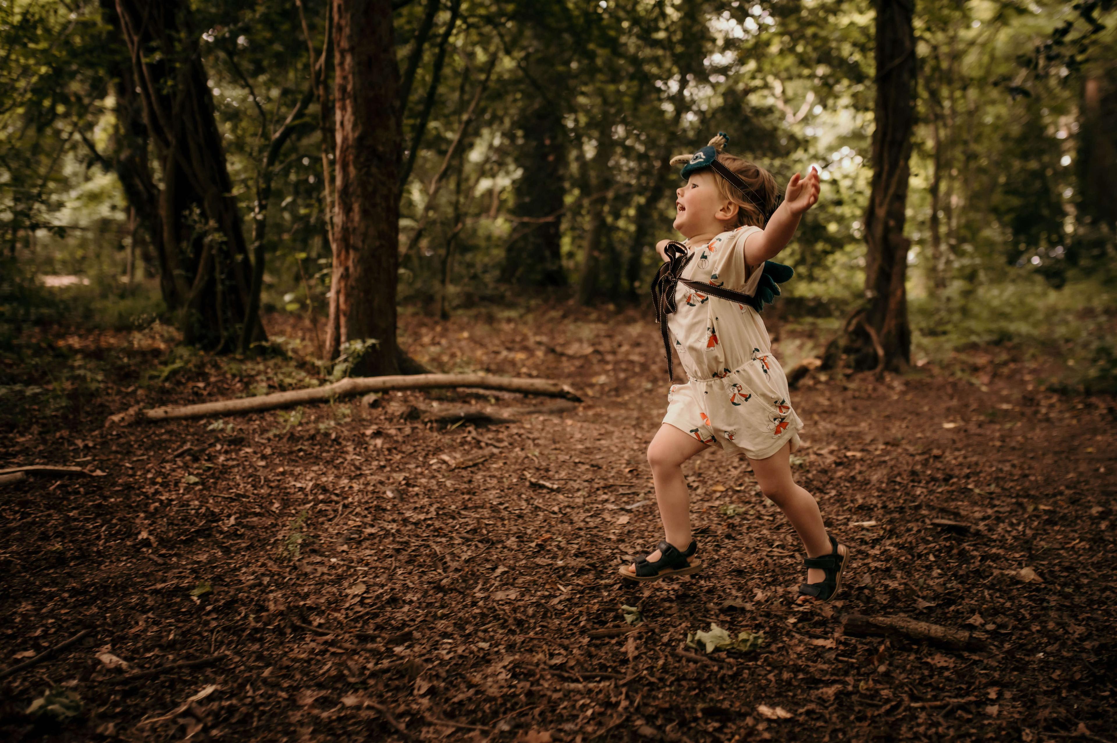 Child running through the woods at Wildlings Nature Play