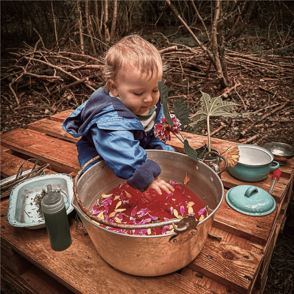 Child running through the woods at Wildlings Nature Play