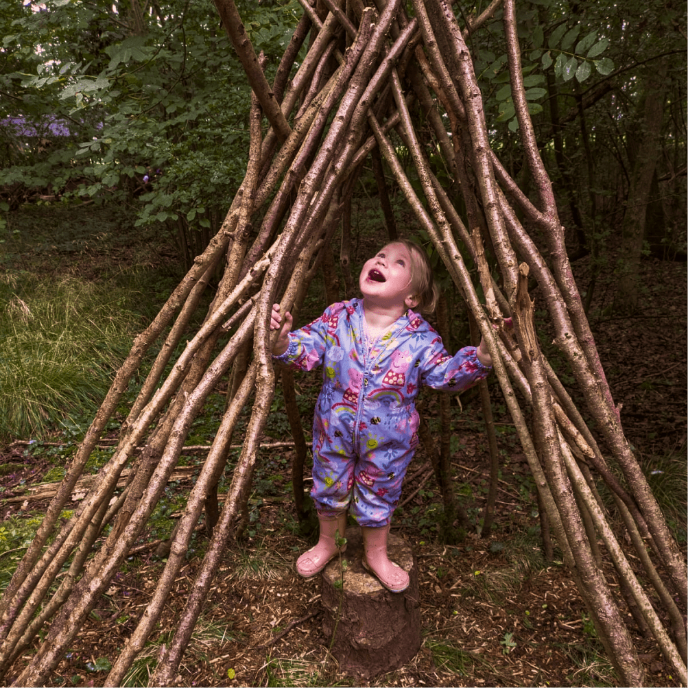 Child running through the woods at Wildlings Nature Play