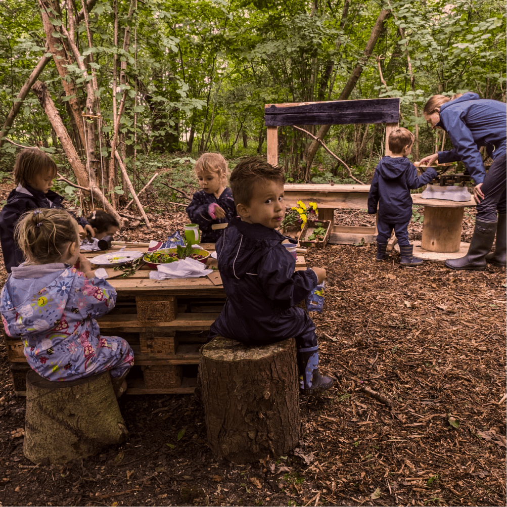 Child running through the woods at Wildlings Nature Play